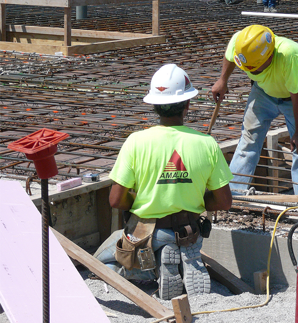 Photo of a worker aligning steel grid photo